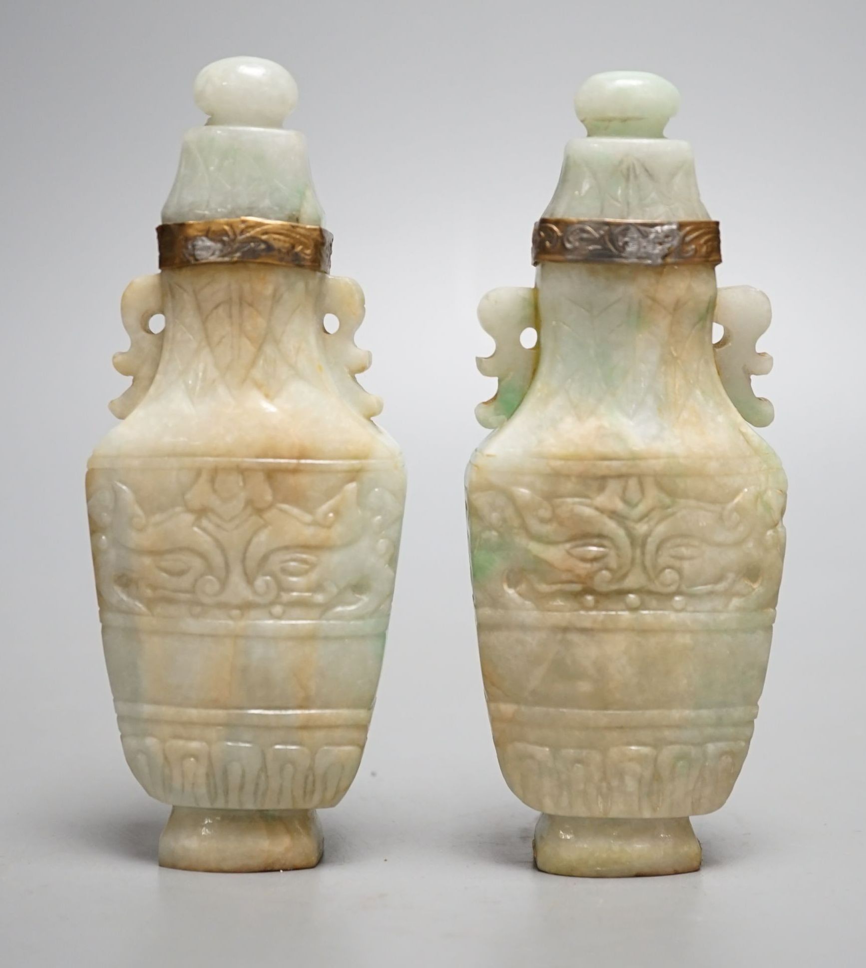 A pair of Chinese jadeite carved vases and covers